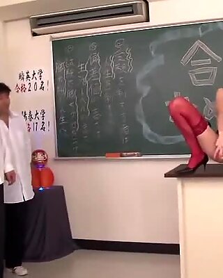 Horny Japanese teacher fucks herself in a classroom